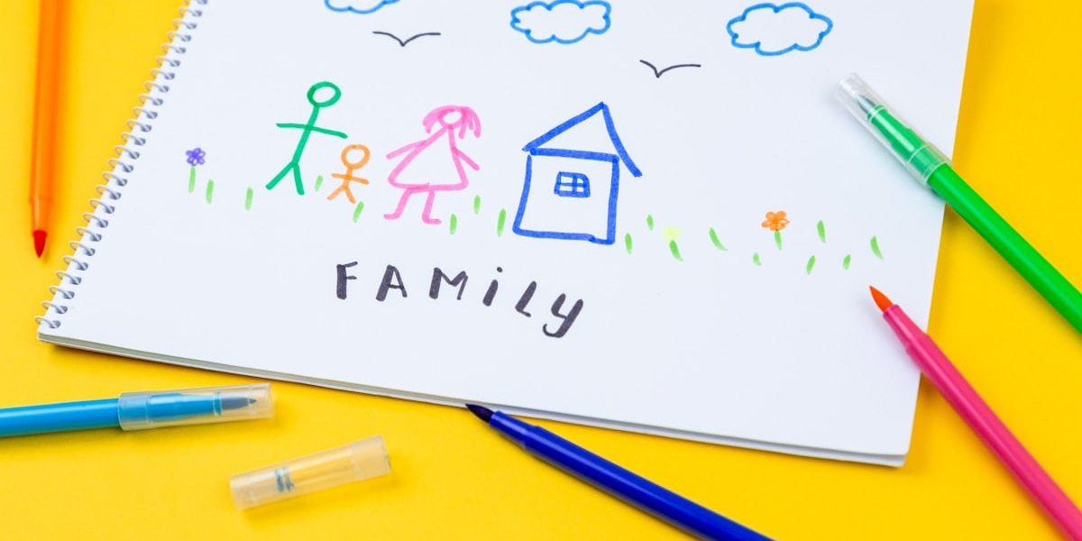 Home, love, family, still life concept. felt-tip pen lying on a paper with children's drawing family. Selective focus, copy space background
